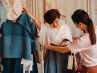 Trying on clothes in a retail fashion store.