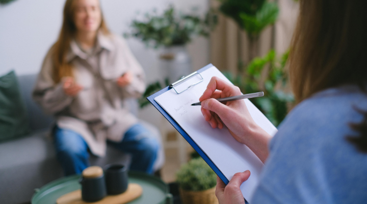 Woman taking notes about client